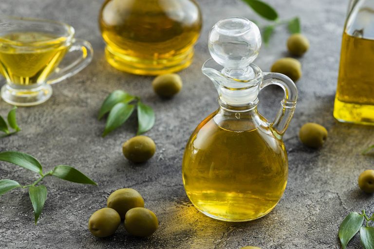 high-view-bottles-filled-with-olive-oil-marble-background